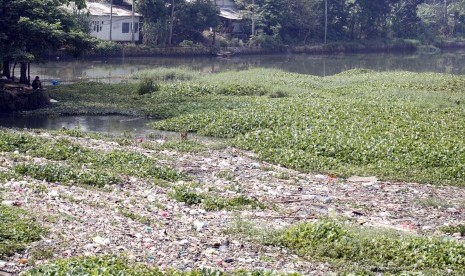 Warga memancing di Situ Pengarengan yang dipenuhi sampah dan gulma eceng gondok di Jalan Juanda, Depok, Jawa Barat, Senin (6/5/2019). 