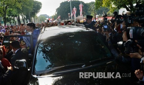 Presiden RI Ke-6 Susilo Bambang Yudhoyono (kanan) dan Ibu Ani Yudhoyono menyapa warga saat meninggalkan Istana Merdeka, Jakarta, Senin (20/10). 