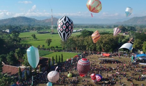 Warga menerbangkan balon udara saat mengikuti Festival Balon Ponorogo 2019 di Desa Nongkodono, Ponorogo, Jawa Timur, Rabu (12/6/2019). 