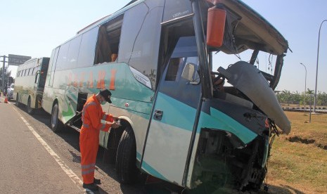 Petugas Komite Nasional Keselamatan Transportasi (KNKT) melakukan identifikasi bus Safari Lux Salatiga yang mengalami kecelakaan di tol Cipali KM 151, Majalengka, Jawa Barat, Senin (17/6/2019). 