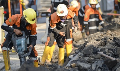 Pekerja membongkar trotoar lama di Jalan Cikini Raya depan Taman Ismail Marzuki (TIM), Jakarta, Rabu (19/6/2019).