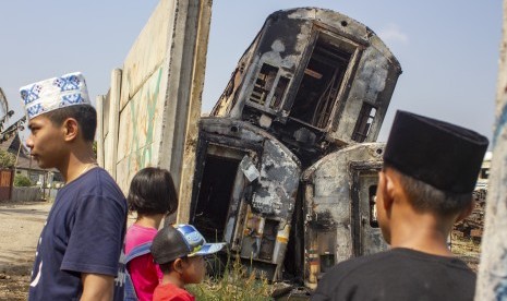 Warga melihat gerbong kereta bekas yang hangus terbakar di area penyimpanan di Stasiun Purwakarta, Purwakarta, Jawa Barat, Sabtu (6/7/2019). 