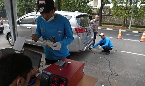 Petugas Sudin Lingkungan Hidup DKI Jakarta melakukan uji emisi kendaraan bermotor di kawasan Lapangan Banteng, Jakarta, Sabtu (6/7/2019). 