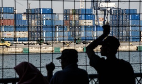 Warga melihat aktivitas bongkar muat peti kemas di Pelabuhan Tanjung Priok, Jakarta, Senin (15/7/2019). 