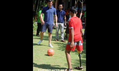 Mantan pesepak bola Manchester United Gary Neville (kiri) bermain sepak bola bersama penyandang disabilitas saat mengunjungi Annika Linden Centre di Denpasar, Bali, Senin (22/7/2019).