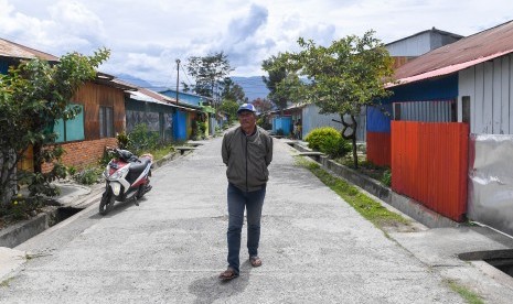 Seorang warga melintas di perumahan yang masih ditinggal mengungsi pemiliknya di kawasan Homhom, Kota Wamena, Kabupaten Jayawijaya, Papua, Kamis (10/10/2019).