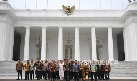 Presiden Joko Widodo (tengah) didampingi Ibu Negara Iriana Joko Widodo (kedelapan kiri) bersama Wakil Presiden Jusuf Kalla (kelima kanan) dan Ibu Wakil Presiden Mufidah Jusuf Kalla (keempat kanan) berfoto bersama sejumlah menteri sebelum acara silaturahmi kabinet kerja di Istana Merdeka, Jakarta, Jumat (18/10/19). 