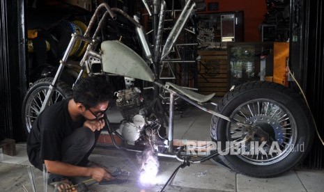 Pekerja mengerjakan modifikasi motor pesanan di bengkel usaha rumahan di Kawasan Jalan Sunggal Medan, Sumatera Utara, Kamis (21/11/2019).