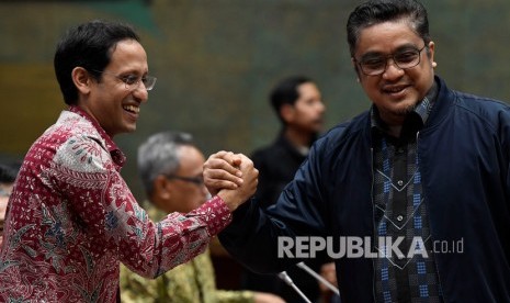 Menteri Pendidikan dan Kebudayaan Nadiem Makarim (kiri) berjabat tangan dengan Wakil Ketua Komisi X DPR Dede Yusuf sebelum mengikuti rapat kerja di Kompleks Parlemen Senayan, Jakarta, Kamis (12/12/2019). 