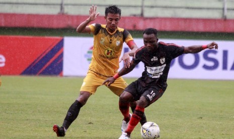 Pesepak bola Persipura Ibrahim Conteh (kanan) berebut bola dengan pesepak bola Barito Putra Bayu Pradana (kiri) pada lanjutan Liga 1 2019 di Stadion Gelora Delta Sidoarjo, Jawa Timur, Senin (16/12/2019). 