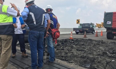 Petugas jasa marga memantau perbaikan jalan tol layang Jakarta-Cikampek, Jakarta Rabu (18/12)