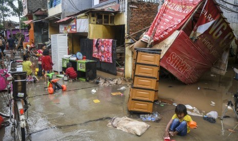 Sejumlah anak bermain di depan rumahnya pascabanjir di Kawasan Cipinang Melayu, Jakarta, Kamis (2/1/2020). Waspadalah, orang yang huniannya tergenang air berisiko terserang penyakit pascabanjir.