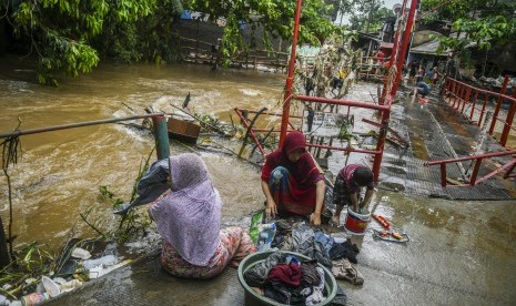 Warga membersihkan perabotan rumah dari endapan lumpur pascabanjir di Kawasan Cipinang Melayu, Jakarta, Kamis (2/1/2020).