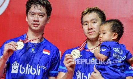 Pebulu tangkis ganda putra Indonesia Kevin Sanjaya Sukamuljo (kiri) dan rekannya Marcus Fernaldi Gideon memegang medali usai mengalahkan lawan senegara Hendra Setiawan dan Mohammad Ahsan dalam pertandingan babak final Daihatsu Indonesia Masters 2020 di Istora Senayan, Jakarta, Ahad (19/1/2020). 