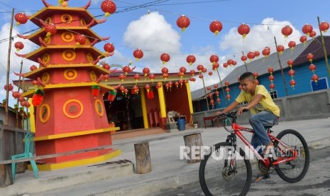 Seorang bocah bersepeda melintas di depan Klenteng di kawasan Kota Tua Penagi, Ranai, Natuna, Kepulauan Riau, Rabu (5/2/2020).