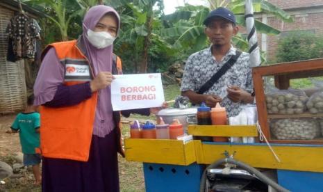 Relawan Rumah Zakat Hikmah Fitria melalui Program Borong Berbagi, memborong dagangan Mu’i. 