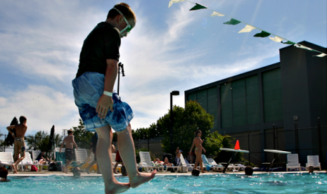 A boy jumps into a pool in Seattle. (illustration)