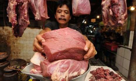 A butcher scales local meat in Pasar Minggu, Jakarta.