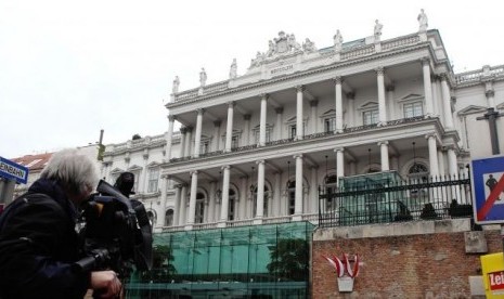 A cameraman films outside Palais Coburg hotel where nuclear talks are taking place in Vienna February 19, 2014.