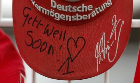 A cap marking the 45th birthday of seven-times former Formula One world champion Michael Schumacher is placed on a fence outside Schumacher's cart racing track in the western city of Kerpen January 3, 2014. 