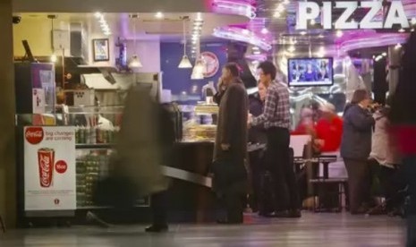 A Coca-Cola poster about the city's new beverage ban is displayed at a pizza shop, Friday, March 8, 2013, at New York's Penn Station.  