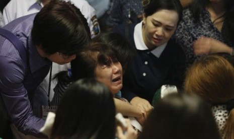 A family member of passengers onboard missing AirAsia flight QZ8501 react at a waiting area in Juanda International Airport, Surabaya December 30, 2014. 