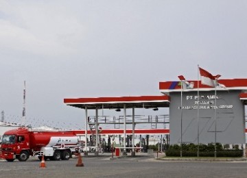 A fuel truck passes a service station at Plumpang, North Jakarta.   