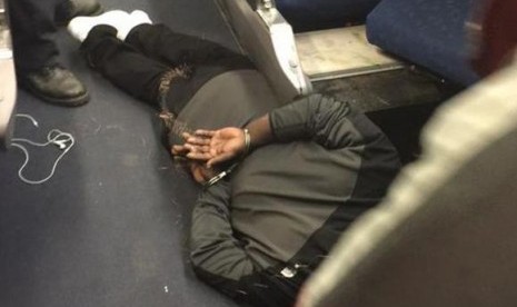 A man is seen in custody aboard an Amtrak train following a stabbing incident in Niles, Michigan December 5, 2014. 