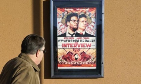 A man walks by the poster for the film ''The Interview'' outside the Alamo Drafthouse theater in Littleton, Colorado December 23, 2014.