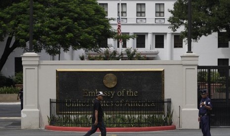 A man walks past the U.S. Embassy in Manila, Philippines on Thursday Sept. 13, 2012 as its flag is on half mast following the death of U.S. diplomats in Libya. Manila police tightened security in the area following the attack that killed the U.S. ambassado