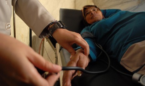 A medical worker examines a patient in a health center set up during homebound session.