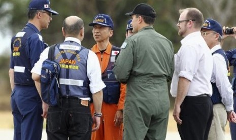 A member of the Japan Coast Guard (third left) is greeted by members of Japan's Disaster Relief Team and Australian officials, at RAAF Pearce airbase near Perth, March 26, 2014.