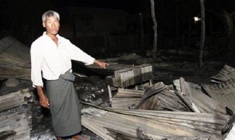 A Muslim man shows his burnt residence in Htan Gone village of Kantbalu township, Sagaing division Myanmar, Sunday, Aug. 25, 2013. 