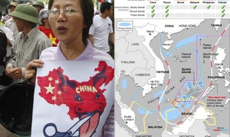 A protester holds an anti-China placard as she marches during a protest along a street in Hanoi July 8, 2012 as some hundred Vietnamese demonstrated in Hanoi on Sunday against China's moves to strengthen its claim on disputed islands in the South China Sea