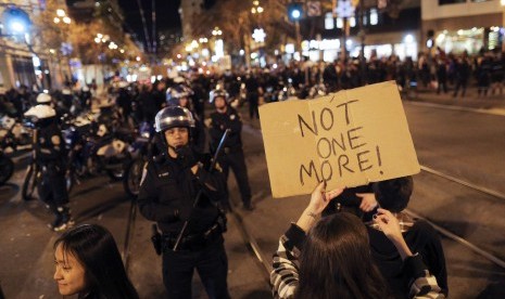 A protester holds up a sign during a demonstration against the grand jury decision in the Ferguson, Missouri shooting of Michael Brown in San Francisco, California November 28, 2014.