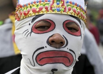 A protester wears a mask during a protest against the government's plan to raise fuel prices, outside the parliament in Jakarta, Indonesia, Friday.