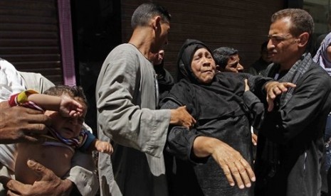 A relative of a Muslim Brotherhood member who was sentenced to death reacts to the verdict outside a courtroom in Minya, Egypt, Saturday, June 21, 2014.