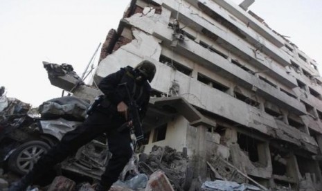 A riot policeman stands outside the building of the Directorate of Security after an explosion in Egypt's Nile Delta town of Dakahlyia, about 120 km (75 miles) northeast of Cairo December 24, 2013.