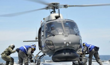 A Royal Malaysian Navy Fennec helicopter prepares to depart to aid in the search and rescue efforts for the missing Malaysia Airlines flight MH370 over the Straits of Malacca. (Handout photo)