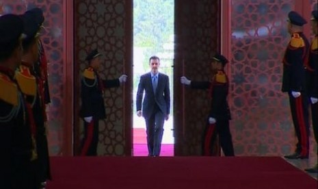 A still image taken from video shows Syria's President Bashar al-Assad arriving to be sworn in for a new seven-year term at the presidential palace in Damascus July 16, 2014.