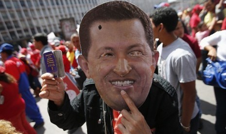 A supporter of Venezuela's President Hugo Chavez wears a mask depicting him during a rally in Caracas, last week. Venezuelans are commemorating the 24th anniversary of the social uprising known as 'Caracazo' which Chavez said marked the start of his revolu