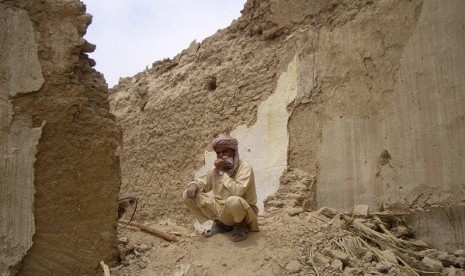 A survivor of Tuesday's earthquake sits on the rubble of his mud house after it collapsed following the quake in the town of Mashkeel, southwestern Pakistani province of Baluchistan, near the Iranian border April 17, 2013. 