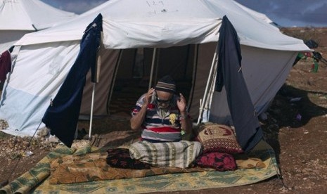 A Syrian elderly disabled man who fled from the violence in his village, prays in front of his tent at a displaced camp, in the Syrian village of Atma, near the Turkish border with Syria. Saturday, Nov. 10, 2012.   