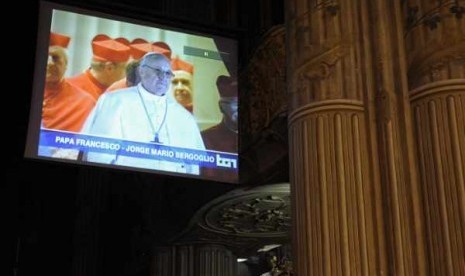 A TV screen shows the newly elected Pope Francis, Cardinal Jorge Mario Bergoglio of Argentina, in the cathedral in Asti March 13, 2013.