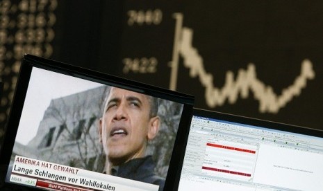 A TV showing news on re-elected U.S. President Barack Obama is pictured in front of the German share price index DAX board at the German stock exchange in Frankfurt November 7, 2012.  