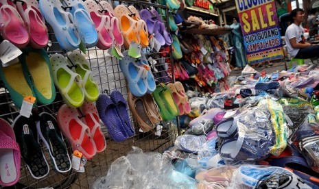 A vendor in Jakarta sells sandals and plastic shoes made in China. (illustration)