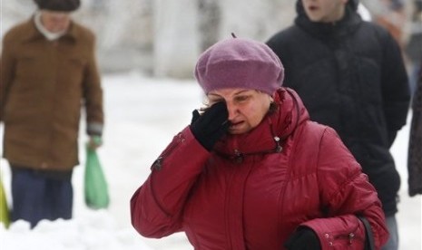 A Volgograd resident walks crying in Volgograd, Russia early Monday, Dec. 30, 2013. 