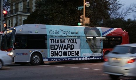 A Washington Metro bus is seen with an Edward Snowden sign on its side panel December 20, 2013.