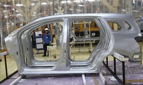 A worker is seen through the frames of car in manufacturing facility in Bekasi, West Java, Indonesia. (illustration)