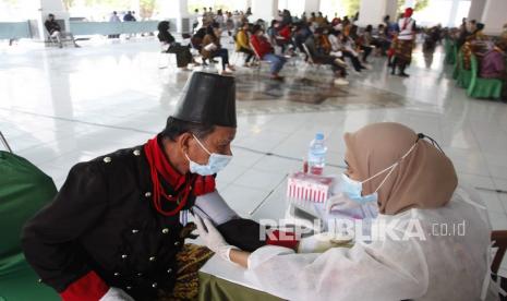 Abdi dalem keraton mengikuti program vaksinasi COVID-19 di Pagelaran Keraton Kasunanan Surakarta Hadiningrat, Solo, Jawa Tengah, Senin (20/7/2021). Vaksinasi digelar dalam rangka membantu pemerintah dalam penanganan COVID-19 dan mencapai kekebalan komunal masyarakat dengan menargetkan 15.000 penerima vaksin dari masyarakat umum dan abdi dalem keraton setempat.